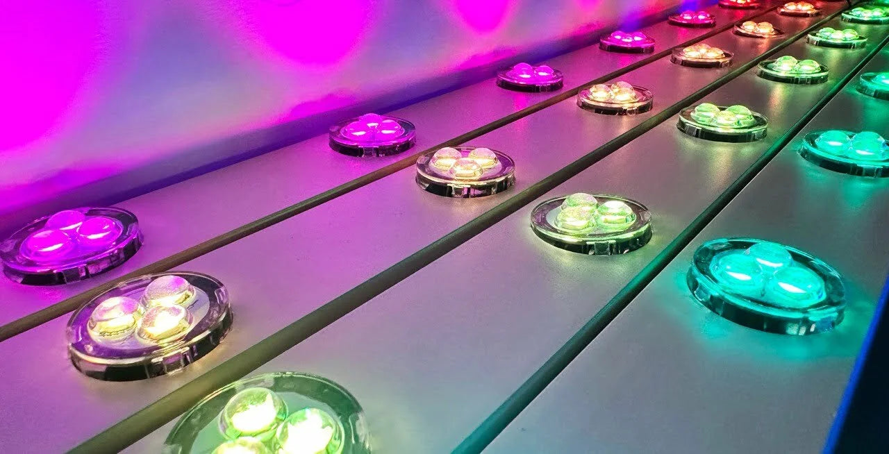 RGBW permanent LED puck lights installed in aluminum track with multiple colors illuminated