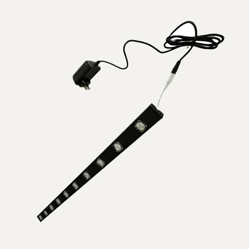 Black permanent LED demo track with ten puck lights, power adapter, and connection cable