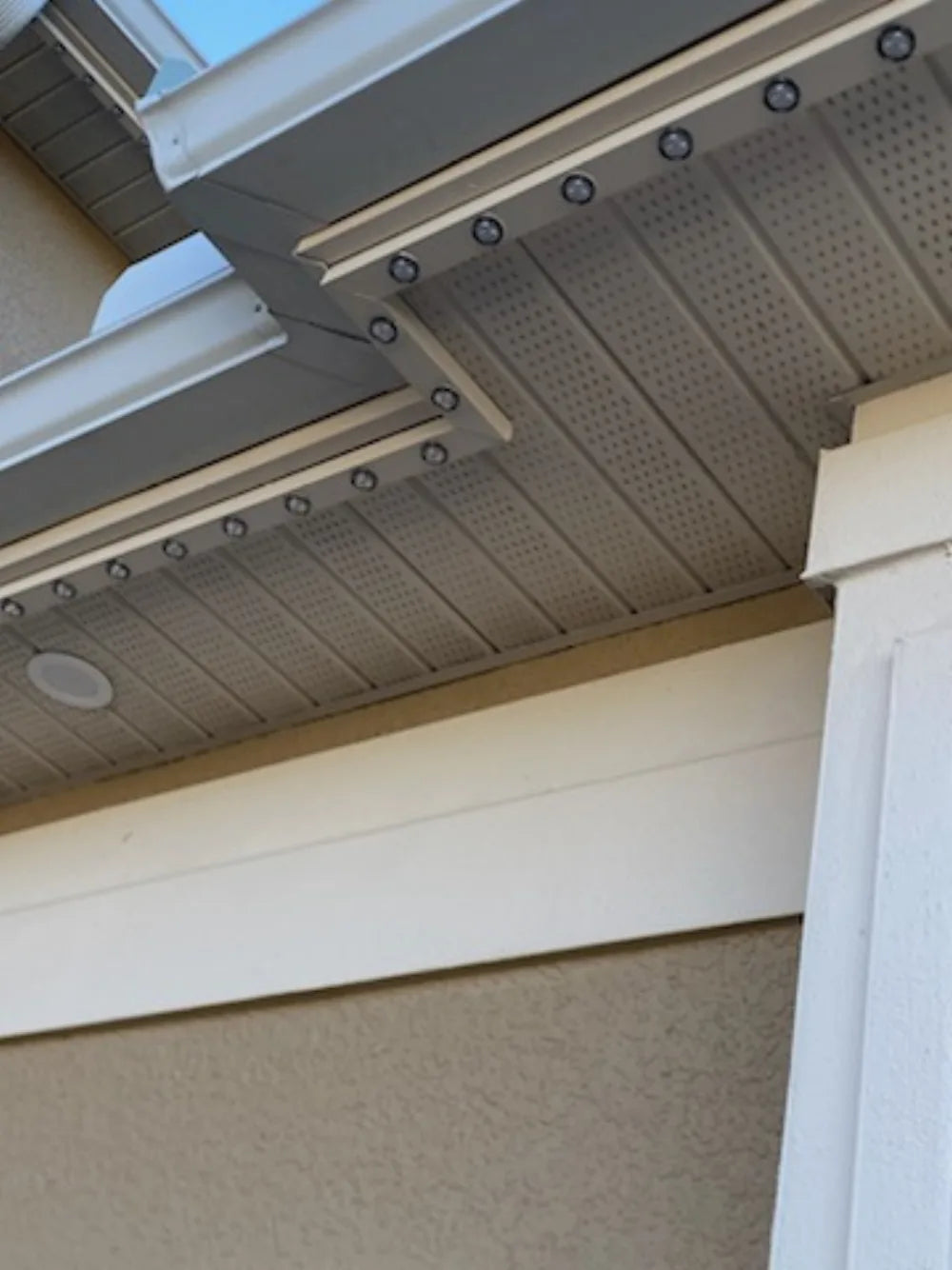 Permanent puck-light track following a stepped soffit transition